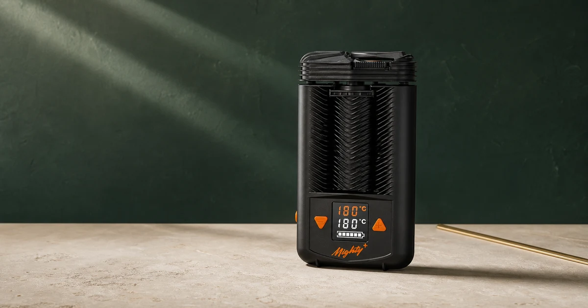 A Storz & Bickel Mighty+ vaporiser photographed against a deep green editorial backdrop.