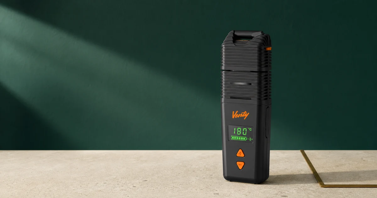 A Storz & Bickel VENTY vaporiser photographed against a deep green editorial backdrop.