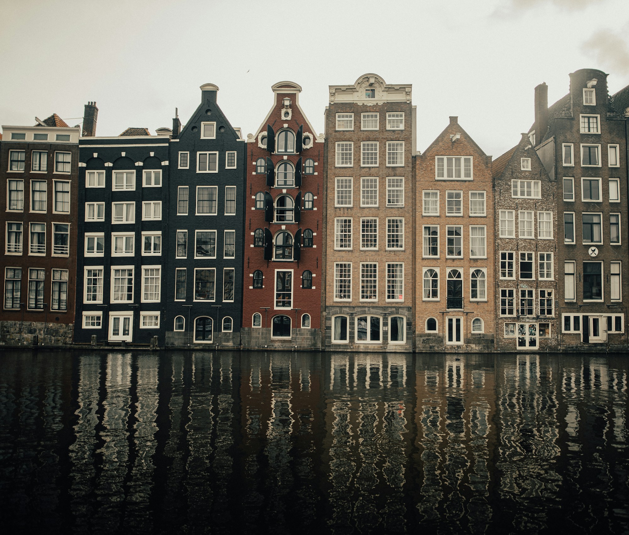 Amsterdam canal houses reflected in the water